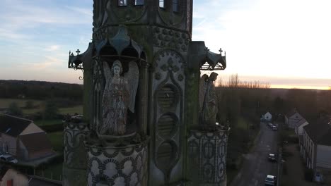 Close-aerial-drone-view-flying-around-a-chapel-in-a-small-village-in-France.